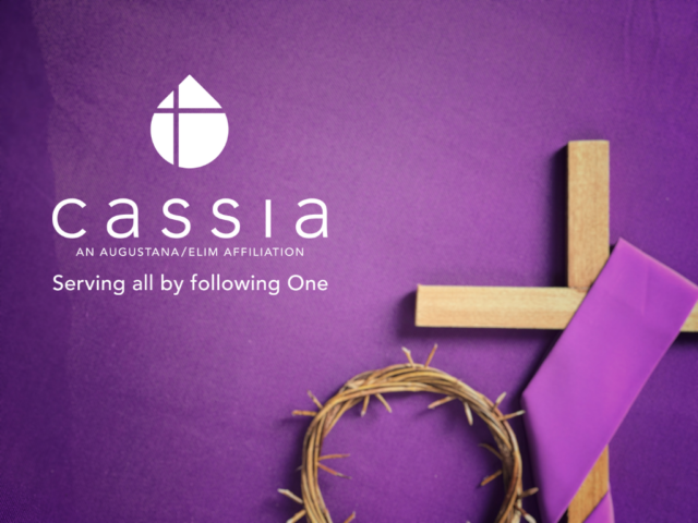 Purple background with purple ribbon and wooden cross and crown of thorns