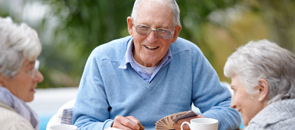 residents outdoors playing cards