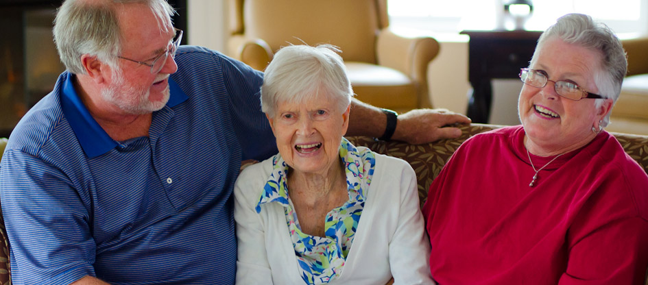 resident and family sitting on a couch